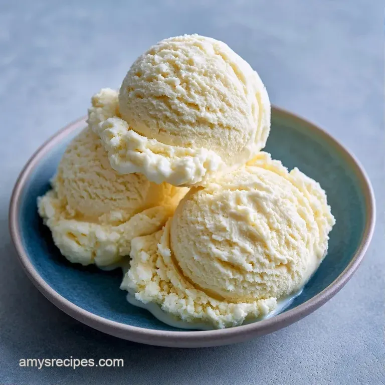 Elegant swirls of white frozen cream in a crystal bowl, garnished with a sprig of mint and a fresh raspberry.