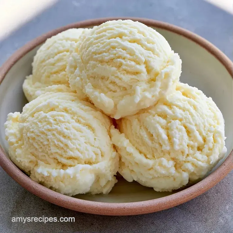 Three smooth scoops of vanilla ice cream in a glass dish topped with a bright mint leaf and a glossy red cherry.