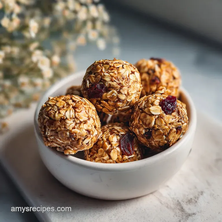 A neat stack of beige, textured protein bites on a matte grey plate, accented by a drizzle of golden honey.
